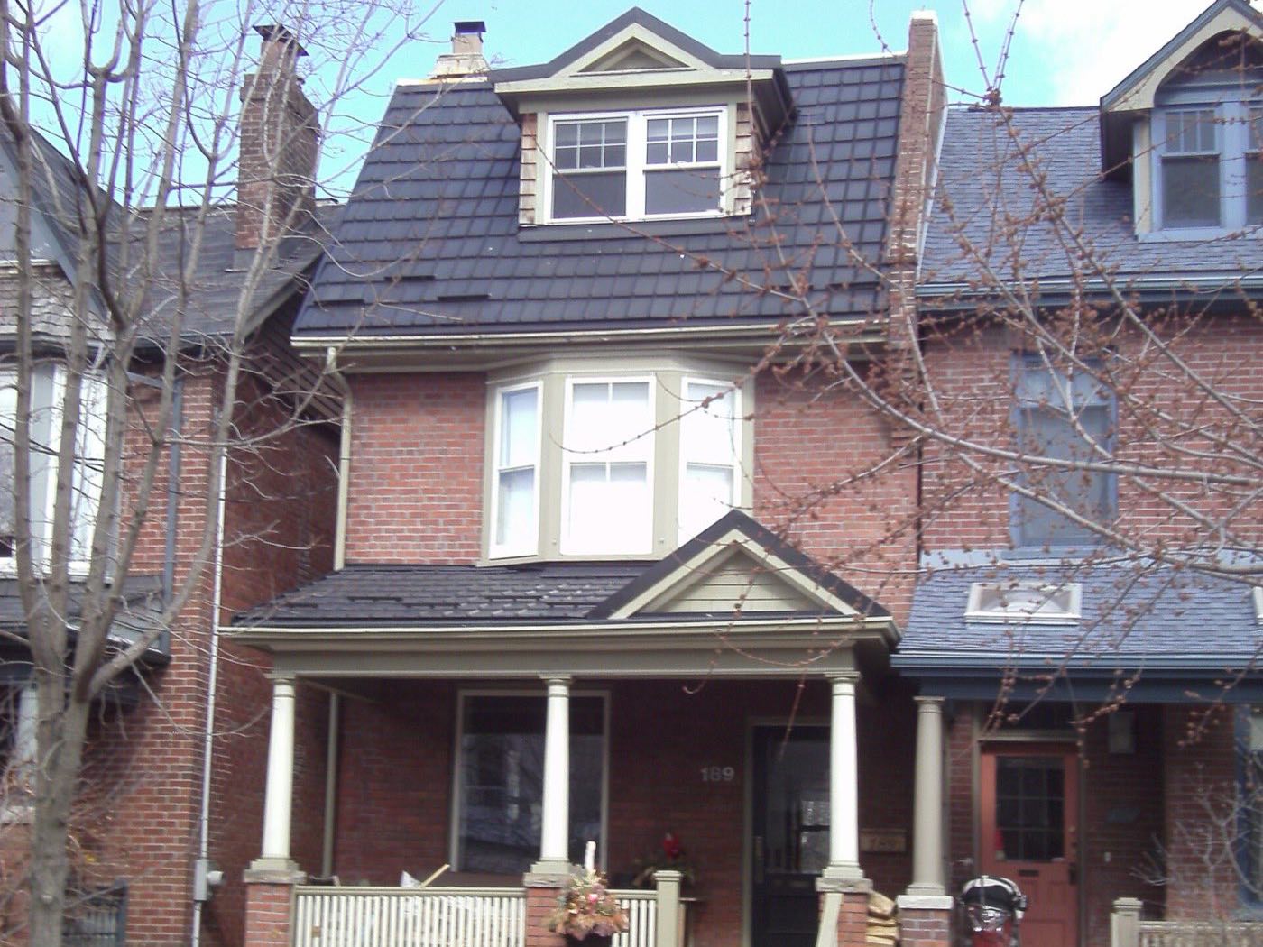 Brick house with a covered front porch in the Annex, Toronto
